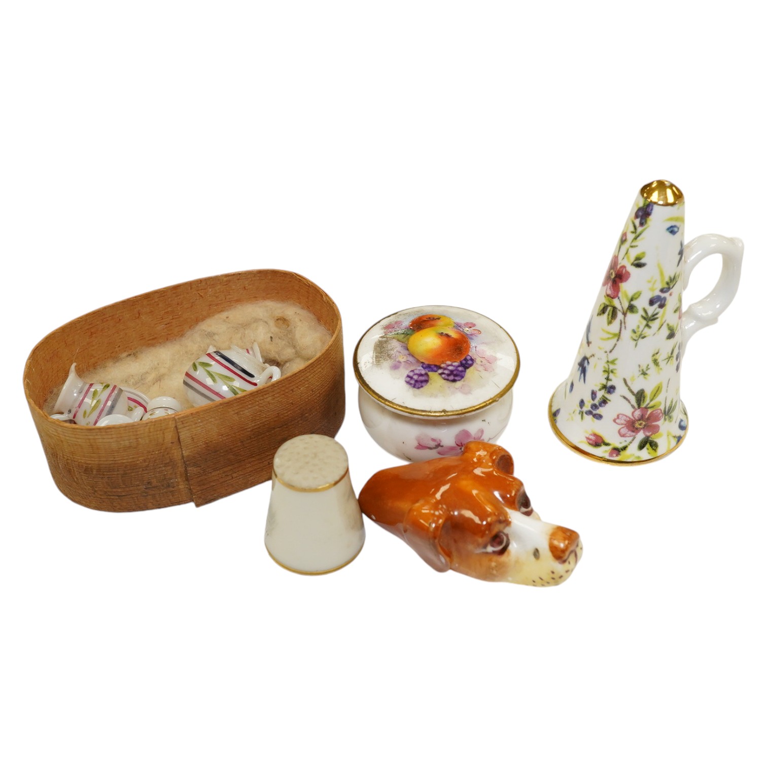 A mixed collection of miniature items including a Royal Worcester hound’s head whistle, a candle extinguisher and a glass tea set, etc., largest 6cm high (6). Condition - good